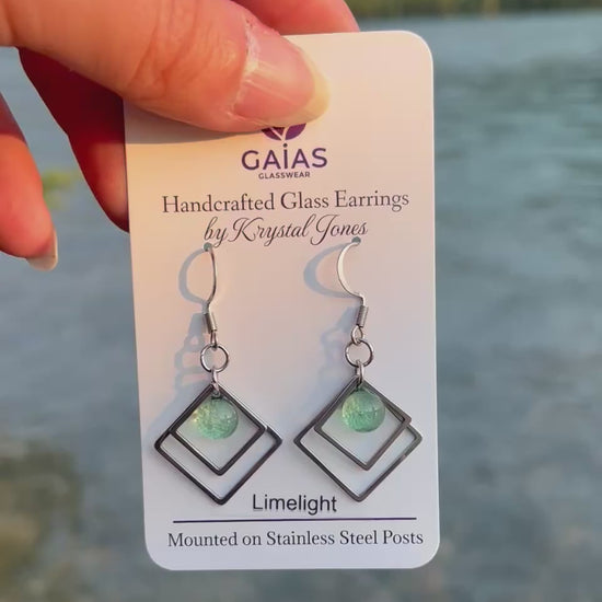 Handmade Limelight geometric fused glass earrings featuring vibrant lime green tones and stainless steel posts, crafted by Canadian glass artist Krystal Jones.