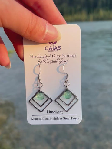 Handmade Limelight geometric fused glass earrings featuring vibrant lime green tones and stainless steel posts, crafted by Canadian glass artist Krystal Jones.
