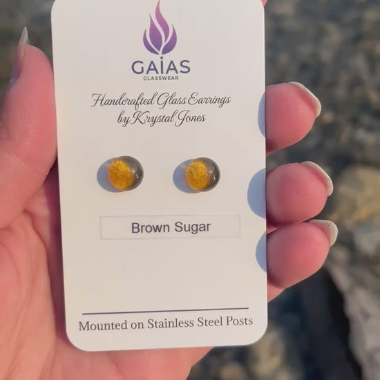 Handmade brown sugar fused glass stud earrings in warm neutral tones with stainless steel posts, crafted by Canadian glass artist Krystal Jones.