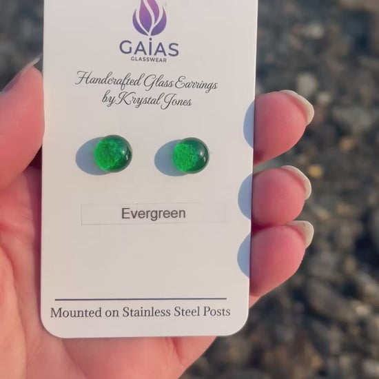 Handmade Evergreen fused glass stud earrings featuring deep forest green tones and stainless steel posts, crafted by Canadian glass artist Krystal Jones.