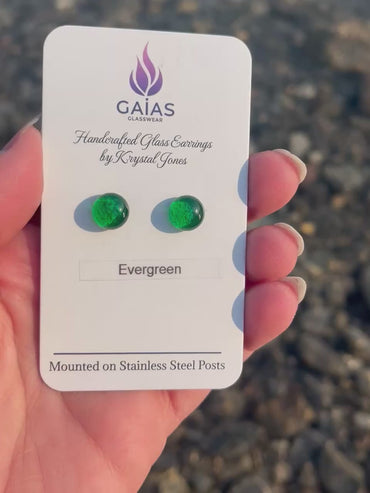 Handmade Evergreen fused glass stud earrings featuring deep forest green tones and stainless steel posts, crafted by Canadian glass artist Krystal Jones.