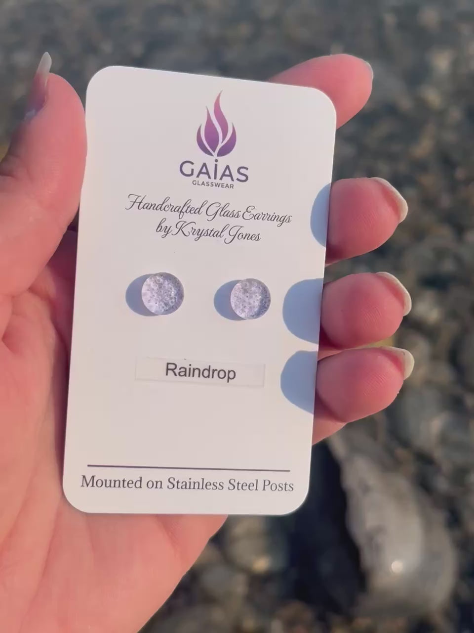 Handmade Raindrop fused glass stud earrings featuring water-inspired blue tones and stainless steel posts, crafted by Canadian glass artist Krystal Jones.
