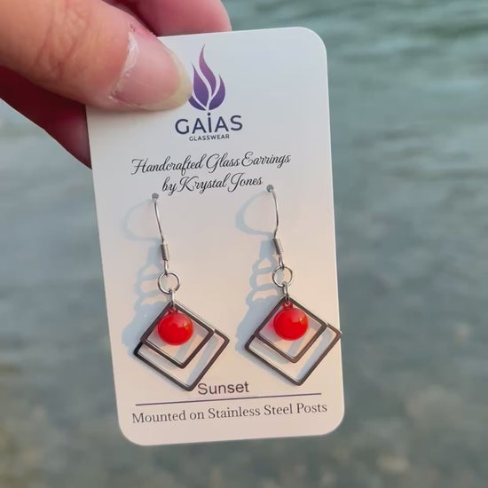 Handmade Sunset geometric fused glass earrings featuring warm orange tones inspired by evening skies, crafted by Canadian glass artist Krystal Jones.