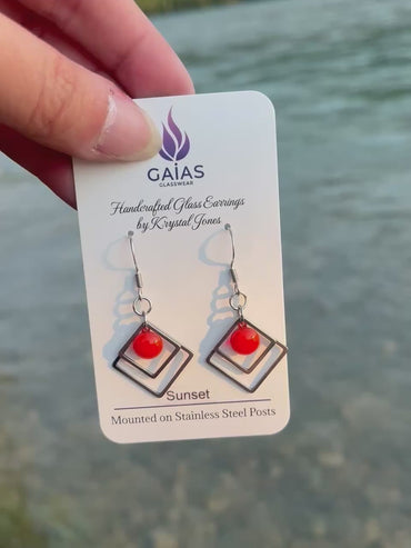 Handmade Sunset geometric fused glass earrings featuring warm orange tones inspired by evening skies, crafted by Canadian glass artist Krystal Jones.