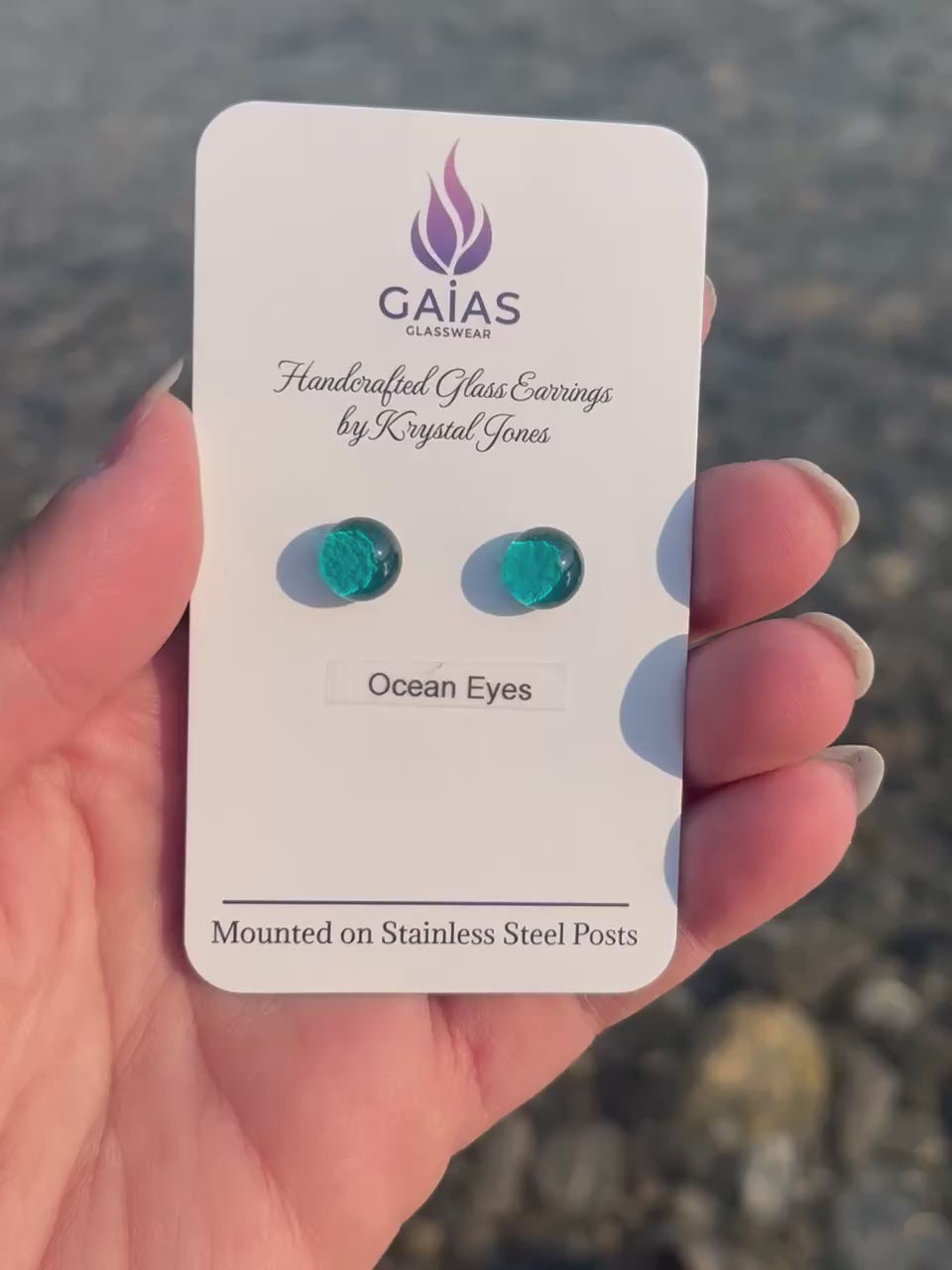 Handmade Ocean Eyes fused glass stud earrings featuring ocean-inspired blue tones and stainless steel posts, crafted by Canadian glass artist Krystal Jones.