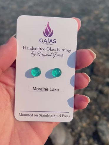 Handmade Moraine Lake fused glass stud earrings inspired by the turquoise waters of the Canadian Rockies, featuring blue and green tones with stainless steel posts, crafted by Canadian glass artist Krystal Jones.