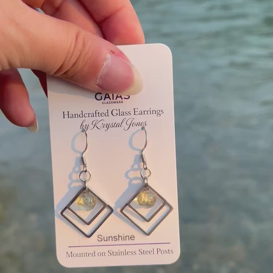 Handmade Sunshine geometric fused glass earrings featuring bright yellow tones and stainless steel posts, inspired by the warmth of sunlight and crafted by Canadian glass artist Krystal Jones.