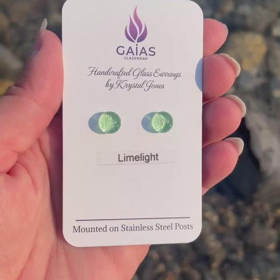 Handmade Limelight fused glass stud earrings featuring vibrant lime green tones and stainless steel posts, crafted by Canadian glass artist Krystal Jones.