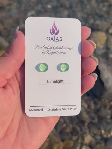 Handmade Limelight fused glass stud earrings featuring vibrant lime green tones and stainless steel posts, crafted by Canadian glass artist Krystal Jones.