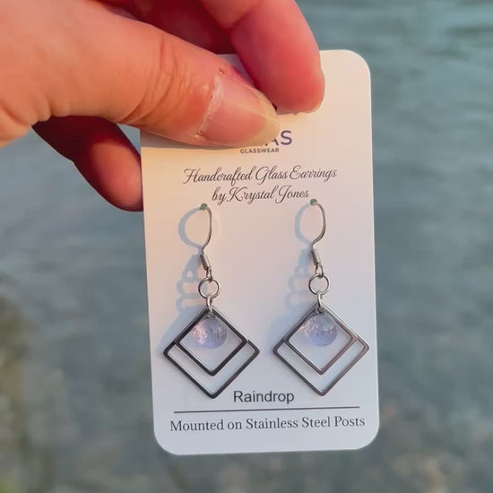 Handmade Raindrop geometric fused glass earrings featuring water-inspired blue tones and stainless steel posts, crafted by Canadian glass artist Krystal Jones.