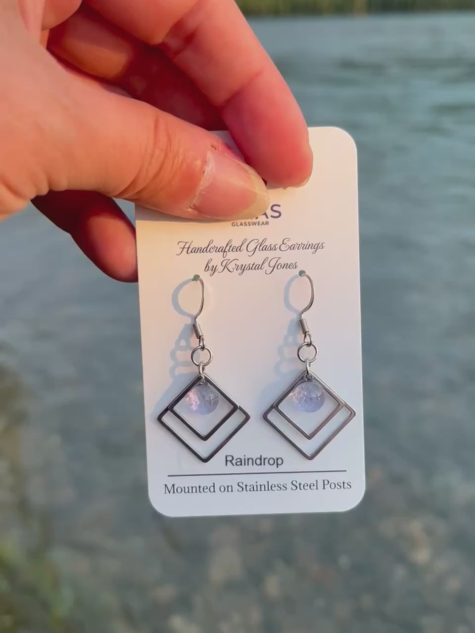 Handmade Raindrop geometric fused glass earrings featuring water-inspired blue tones and stainless steel posts, crafted by Canadian glass artist Krystal Jones.