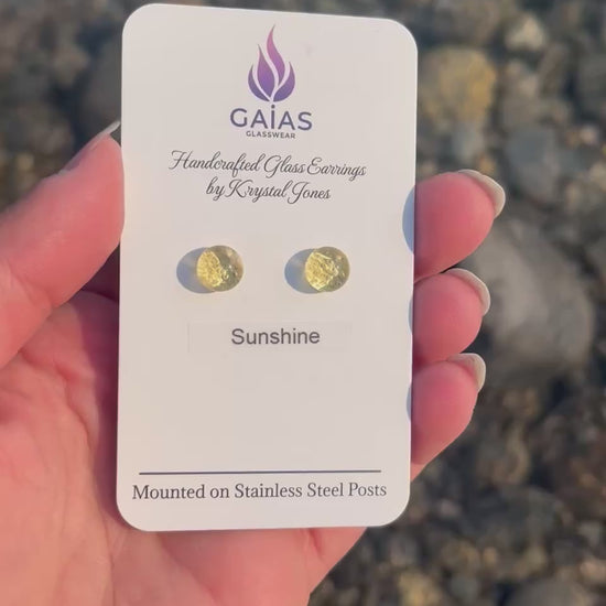 Handmade Sunshine fused glass stud earrings featuring bright yellow tones and stainless steel posts, inspired by the warmth of sunlight and crafted by Canadian glass artist Krystal Jones.
