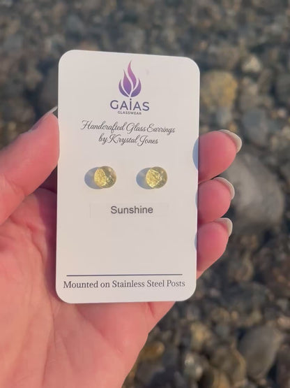 Handmade Sunshine fused glass stud earrings featuring bright yellow tones and stainless steel posts, inspired by the warmth of sunlight and crafted by Canadian glass artist Krystal Jones.