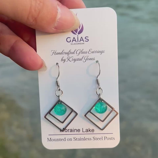 Handmade Moraine Lake geometric fused glass earrings inspired by the turquoise waters of the Canadian Rockies, featuring blue and green tones with stainless steel posts, crafted by Canadian glass artist Krystal Jones.