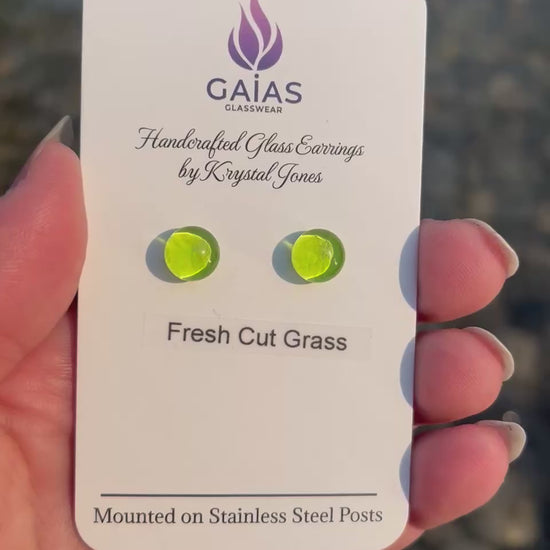 Handmade Fresh Cut Grass fused glass stud earrings featuring vibrant green tones and stainless steel posts, crafted by Canadian glass artist Krystal Jones.