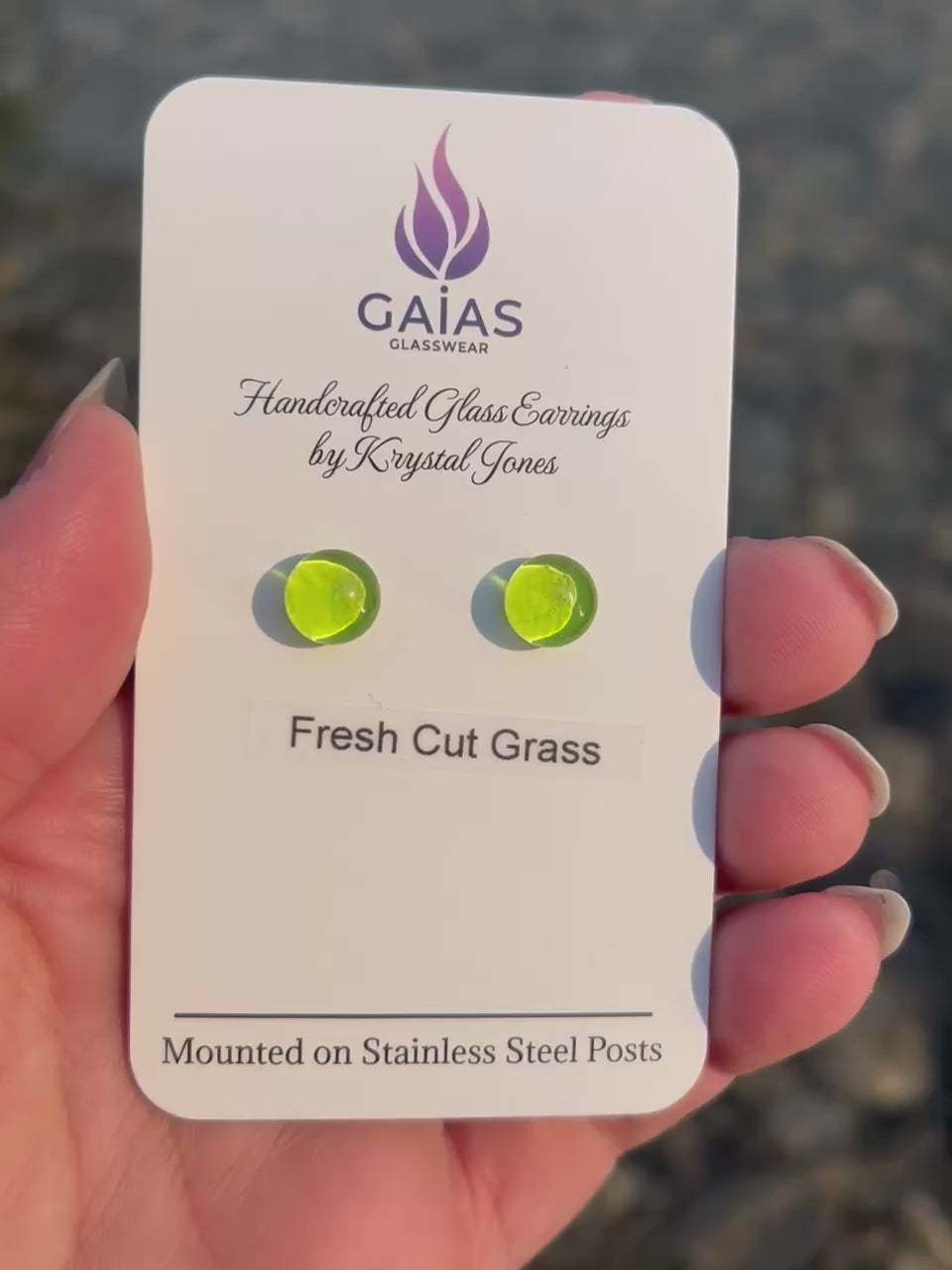 Handmade Fresh Cut Grass fused glass stud earrings featuring vibrant green tones and stainless steel posts, crafted by Canadian glass artist Krystal Jones.