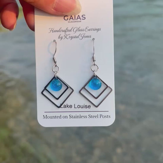 Handmade Lake Louise geometric fused glass earrings inspired by the turquoise waters of the Canadian Rockies, featuring stainless steel posts and crafted by Canadian glass artist Krystal Jones.