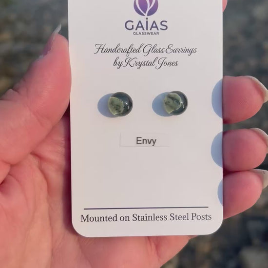 Handmade Envy fused glass stud earrings featuring rich grey tones and stainless steel posts, crafted by Canadian glass artist Krystal Jones.