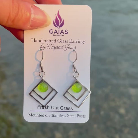 Handmade Fresh Cut Grass geometric fused glass earrings featuring vibrant green tones and a modern design with stainless steel posts, crafted by Canadian glass artist Krystal Jones.
