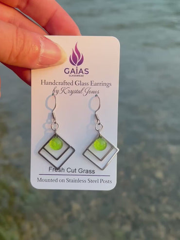 Handmade Fresh Cut Grass geometric fused glass earrings featuring vibrant green tones and a modern design with stainless steel posts, crafted by Canadian glass artist Krystal Jones.