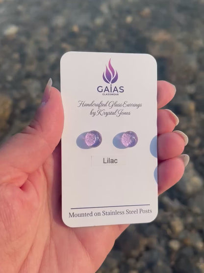 Handmade Lilac fused glass stud earrings featuring soft purple tones and stainless steel posts, crafted by Canadian glass artist Krystal Jones.