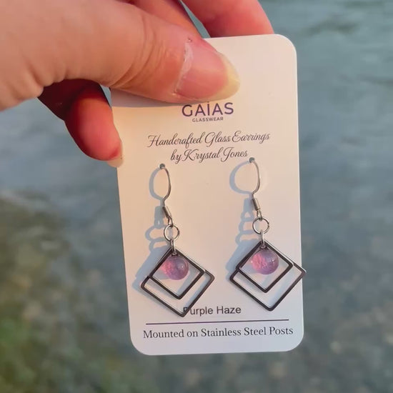 Handmade Purple Haze geometric fused glass earrings featuring rich purple tones and stainless steel posts, crafted by Canadian glass artist Krystal Jones.