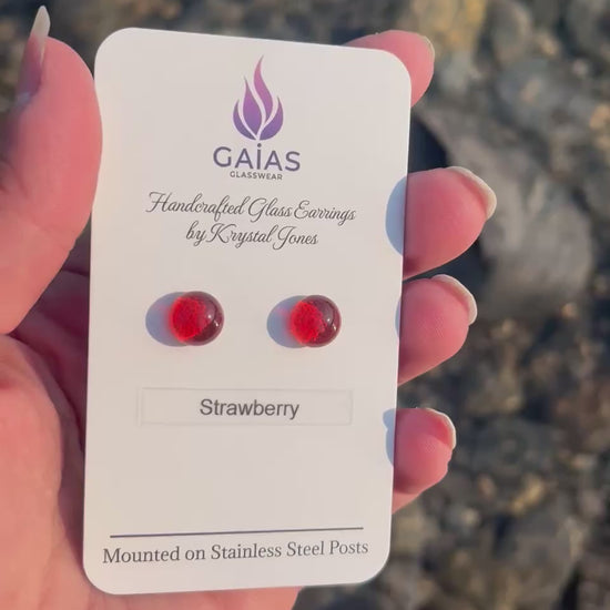 Handmade Strawberry fused glass stud earrings featuring vibrant red tones and stainless steel posts, crafted by Canadian glass artist Krystal Jones.