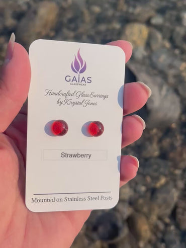 Handmade Strawberry fused glass stud earrings featuring vibrant red tones and stainless steel posts, crafted by Canadian glass artist Krystal Jones.